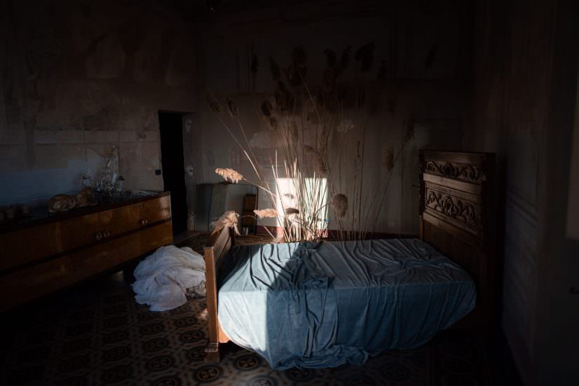 A veil and dress in a softly lit historic bedroom