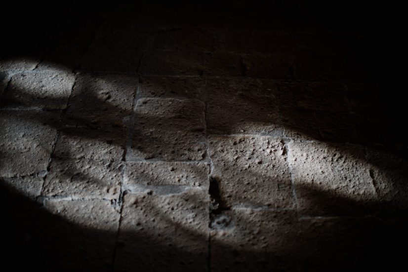 A shaft of sunlight falling across an old stone floor